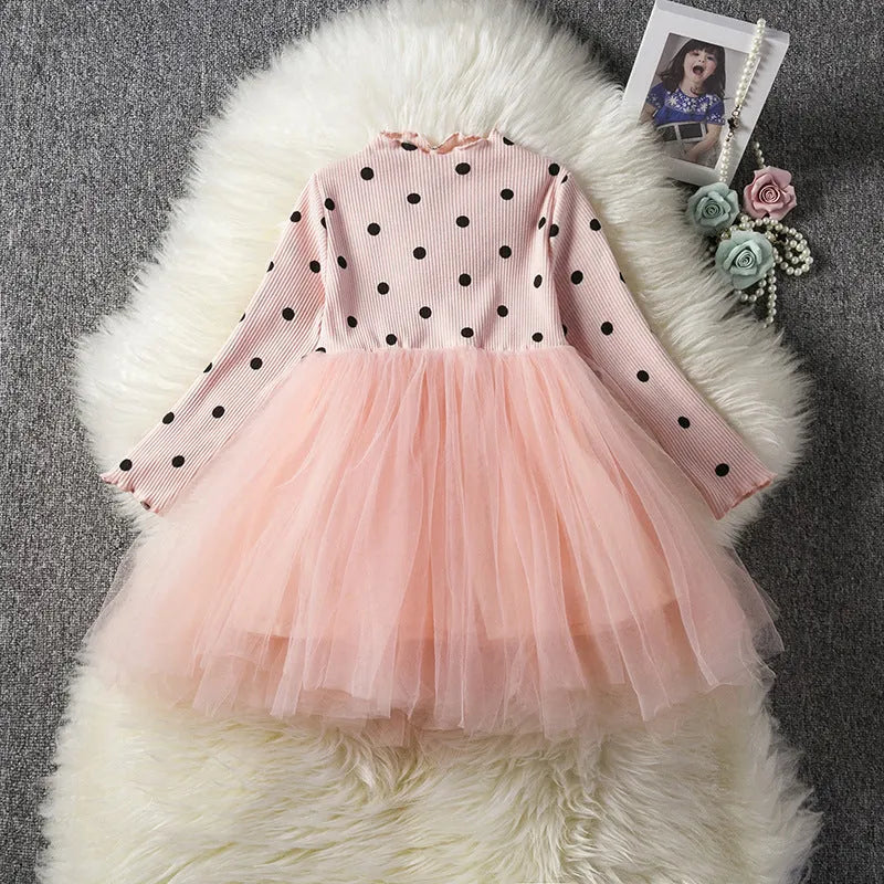 Baby girl in a long sleeve black lace tutu dress, suitable for christenings and parties.