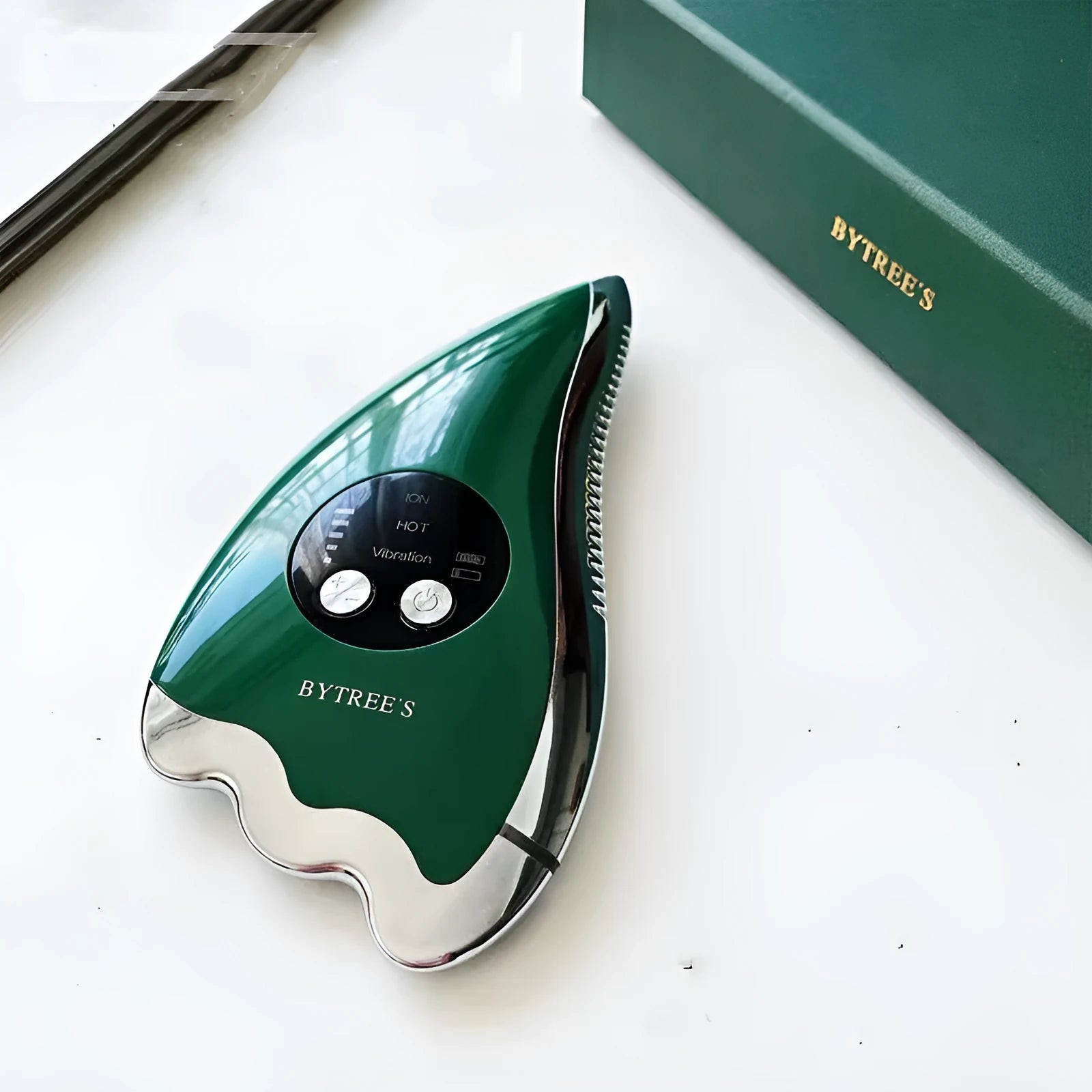 Green plastic and metal facial beauty instrument with three mode buttons and USB cable