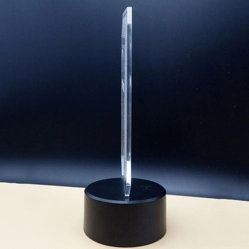 3D acrylic desk lamp with colourful LED illumination and remote control on wooden surface