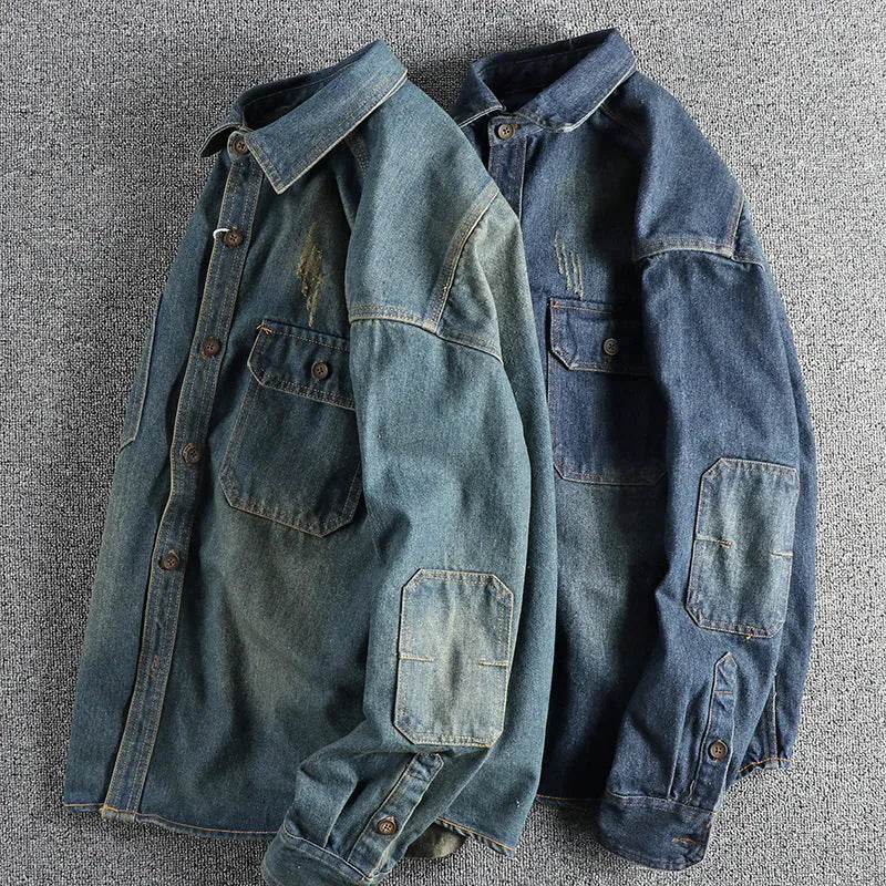 Men's light blue washed vintage denim shirt with a loose fit and long sleeves on a hanger.