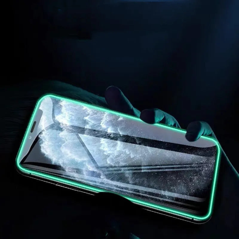 Luminous full cover tempered glass screen protector for iPhone glowing softly in dark conditions.