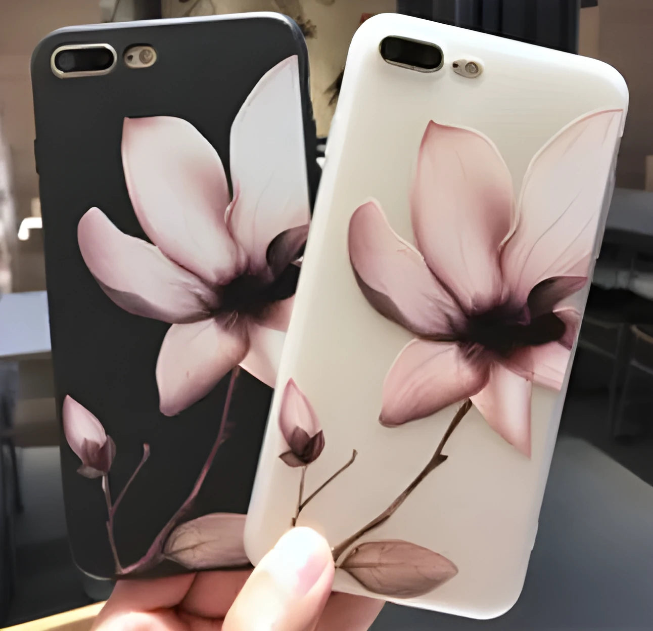 Black and white iPhone TPU cases with a raised embossed floral pattern on the back.
