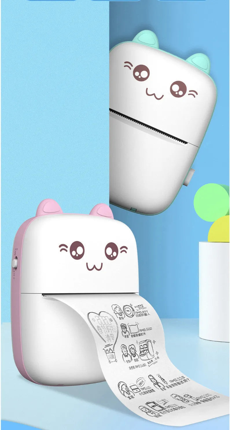 Pink mini Bluetooth thermal printer on a desk with a phone and printed note, measuring 11x8x3.5cm