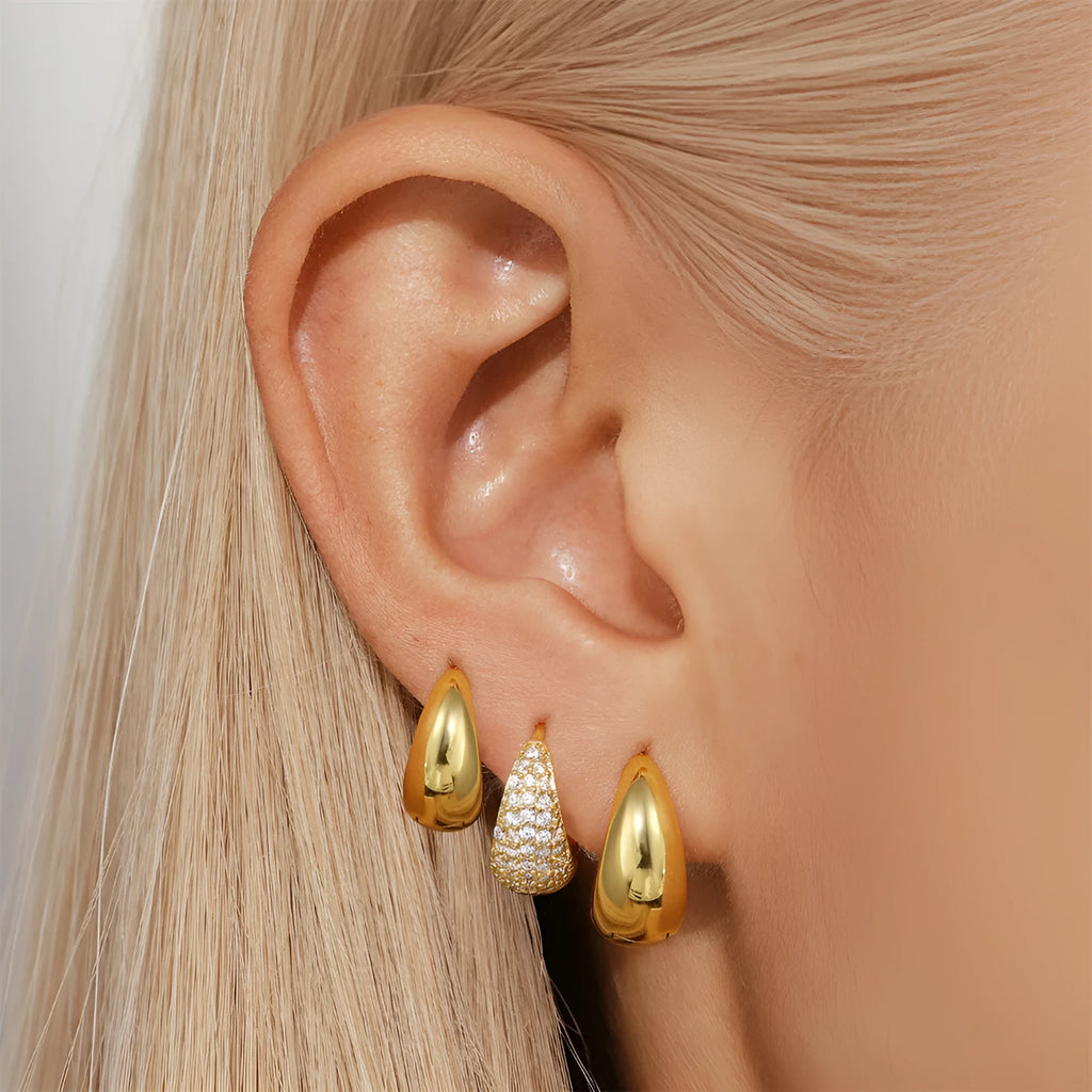 Golden brass diamond earclip earrings with simple geometric round design on white background