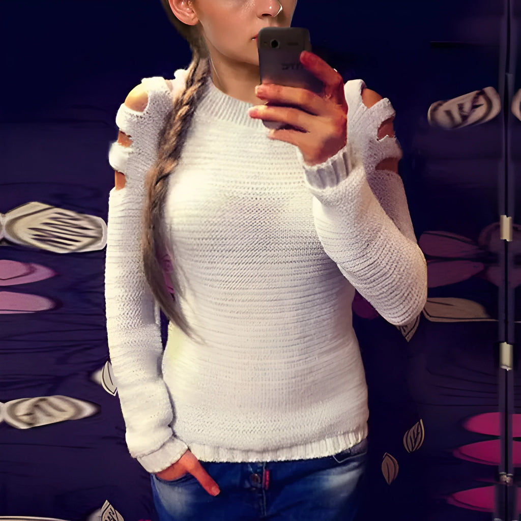 Women's grey hollow-out crochet knitted long sleeve shirt with round neck on a hanger.