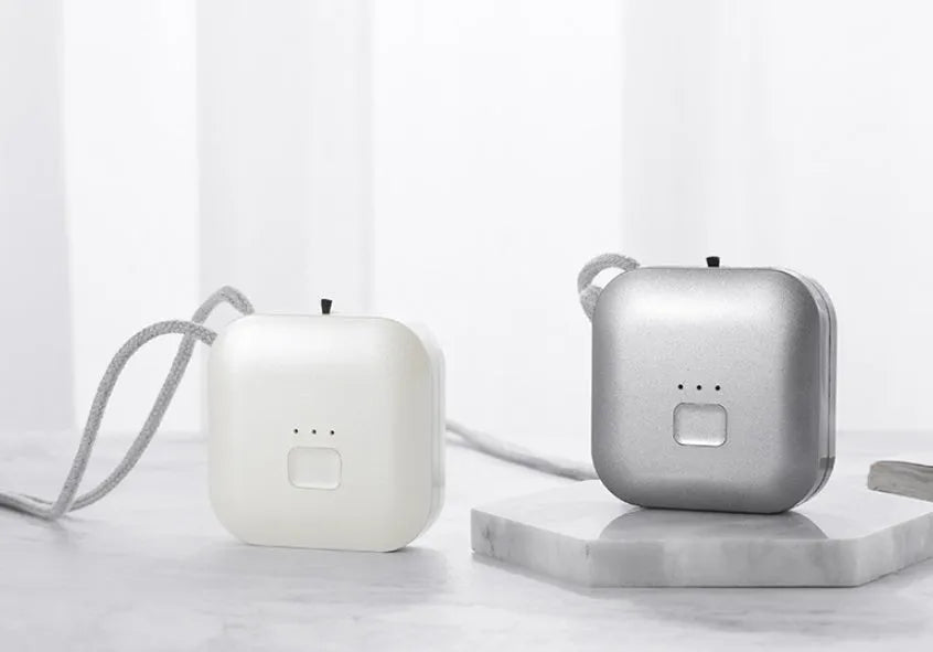 USB rechargeable mini air purifier necklace in blue, showing compact design worn around neck.