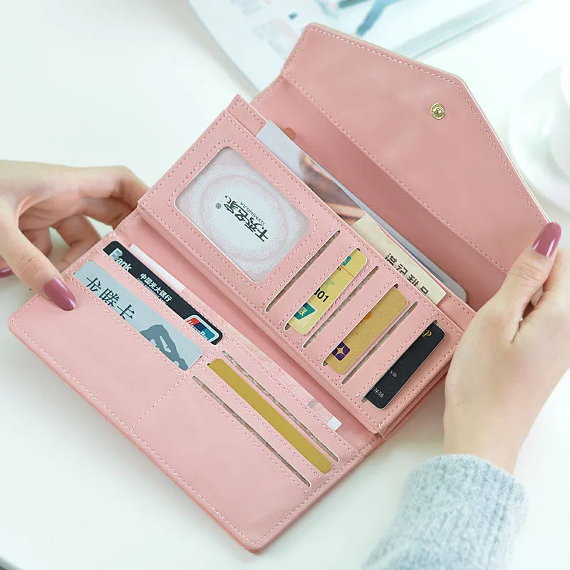 A black three-fold PU leather wallet with a buckle closure and an internal clip, shown open.