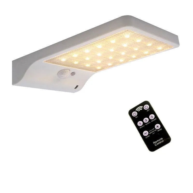 Black and white outdoor solar garden light with solar panel and IP65 waterproof rating.