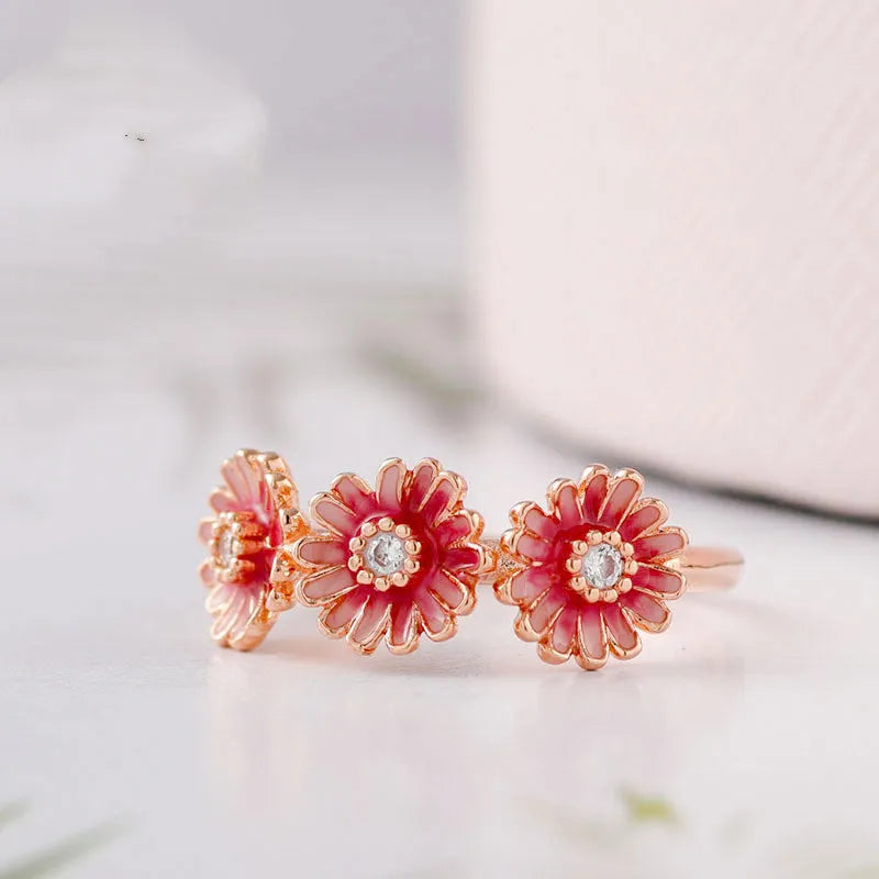 Three pink daisy rings with pink gemstone inlay in 925 sterling silver