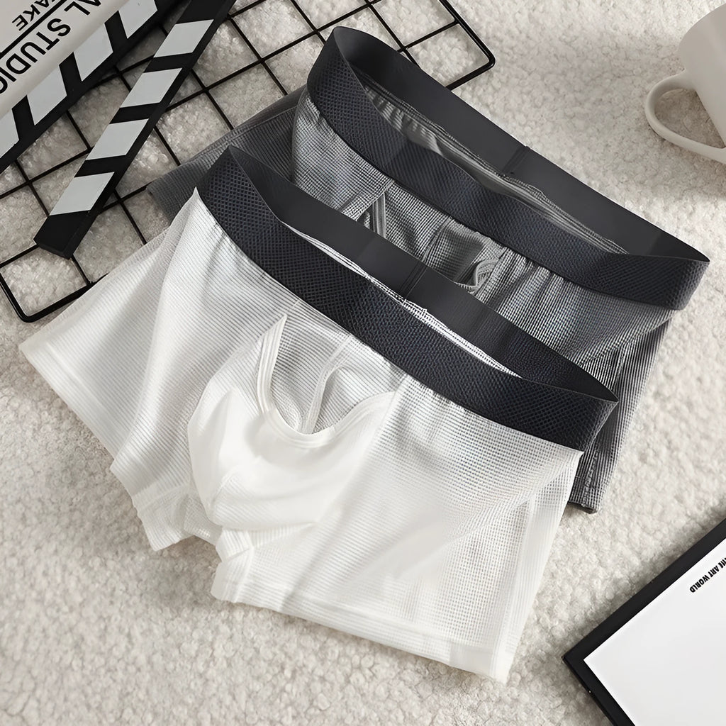 Men's solid colour ice silk boxer shorts on a white background, showing low waist design.