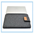 Clamshell laptop bag in khaki, light grey, or dark grey with a woven plush texture and corner protector.
