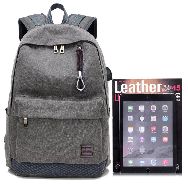Canvas USB charging backpack in grey colour showing front pockets and side USB port.