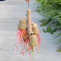 Colourful shredded paper parrot chewing toy with wood and sisal rope construction