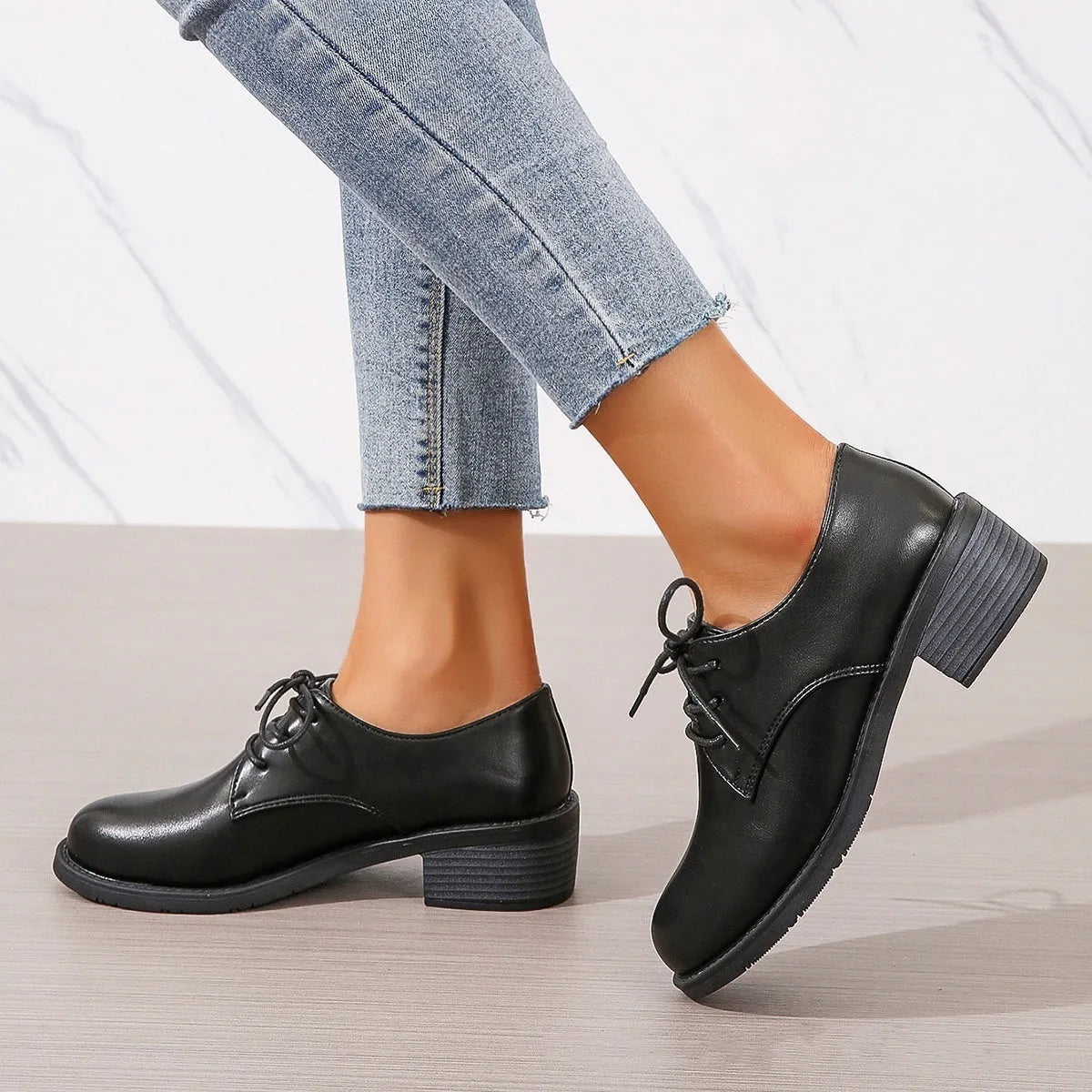 Black women's low-top shoes with a thick chunky heel and rubber sole.