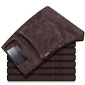 Straight slim-fit cotton corduroy trousers in black, side view, mid-waist, zip-placket fly