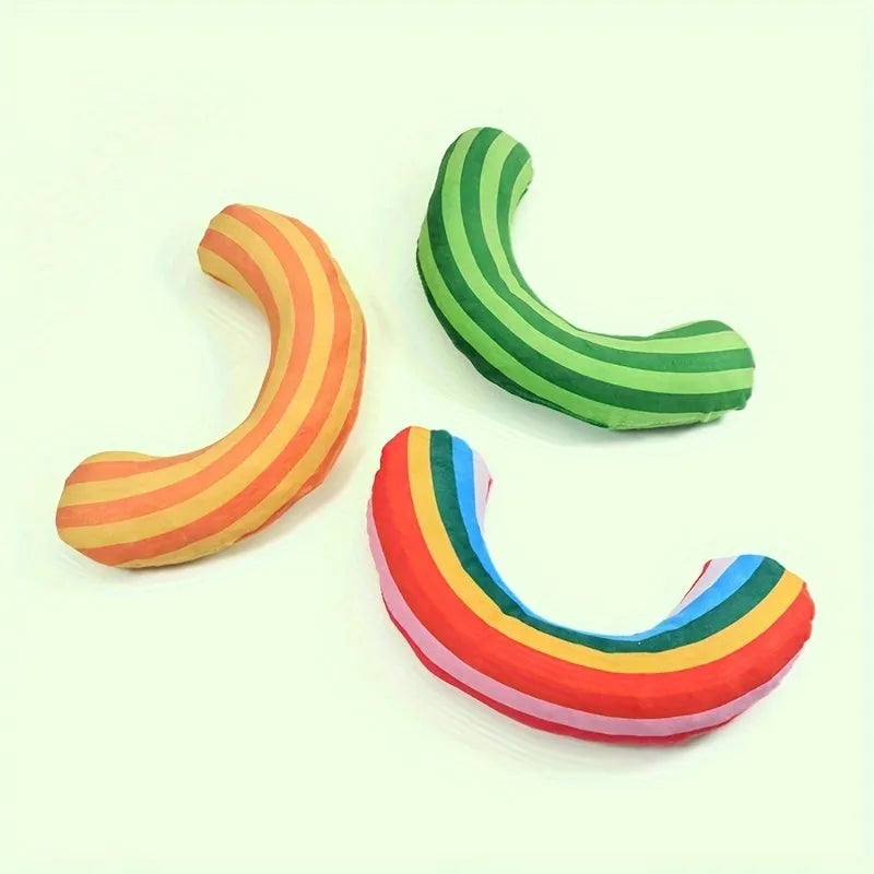 Cat toy set showing noise-making toy with catnip strip and striped pattern cat pillow in green, rainbow, or yellow