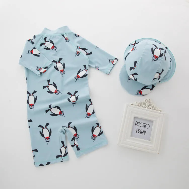 Boys' long sleeve penguin print swimsuit and matching swim cap set on a white background.