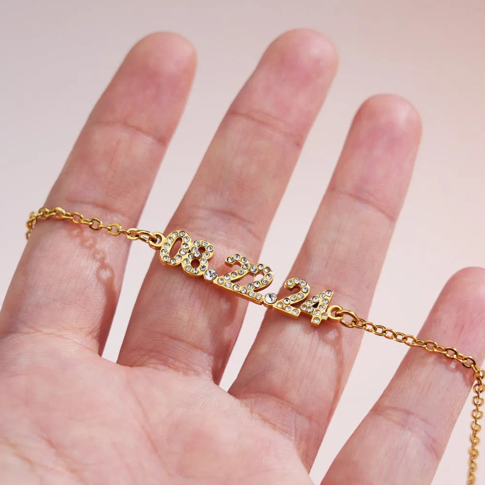 Stainless steel digital bracelet and necklace with diamonds on the numbers, shown in gold, rose gold and steel colour options.