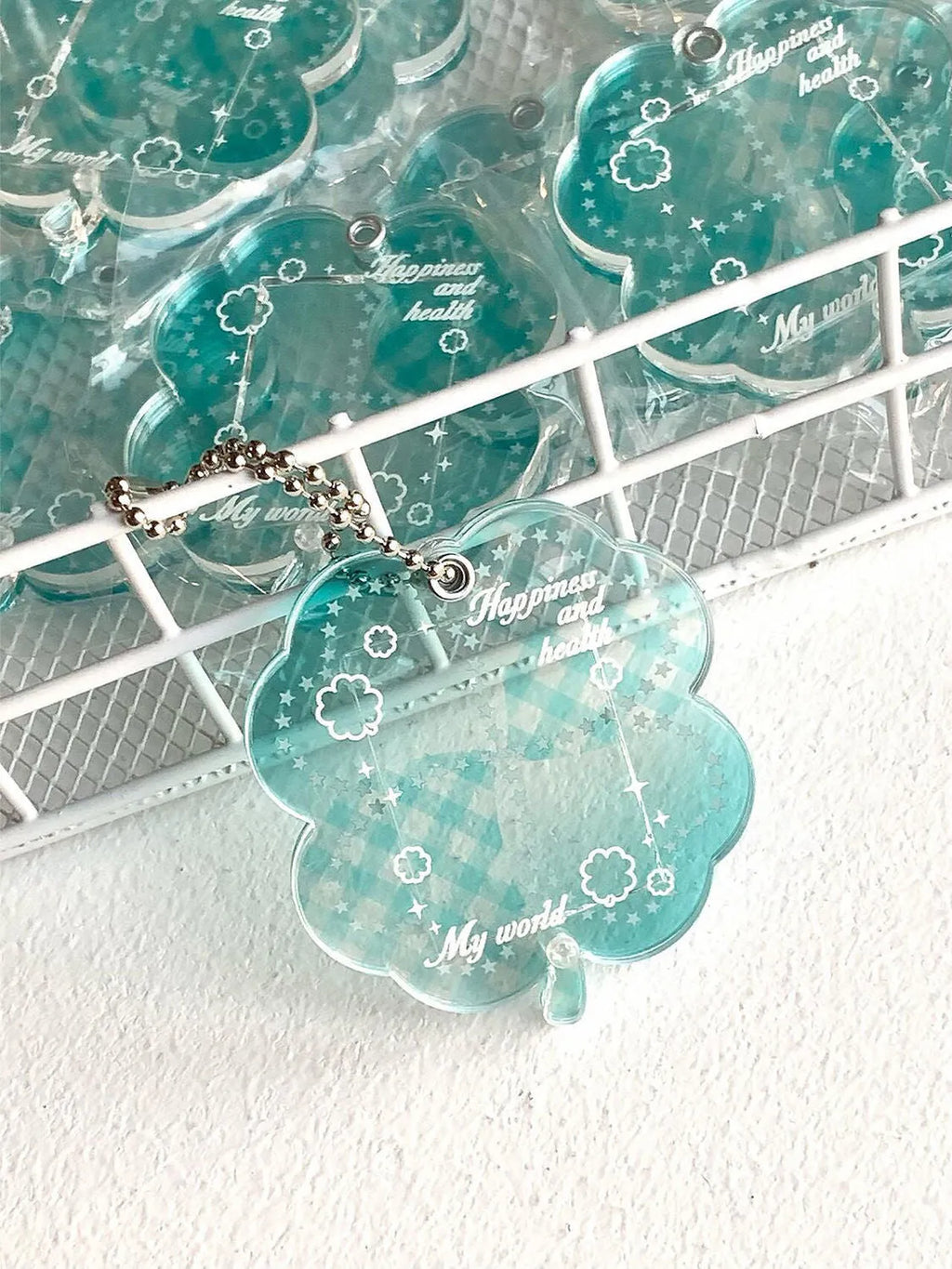 Acrylic four-leaf clover pendant keychain for phones in blue, green, or mint.