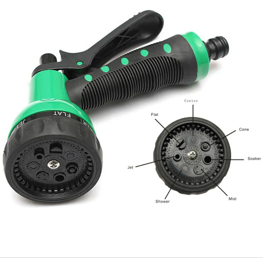 Garden telescopic hose sprinkler with ABS gun head extended on a lawn