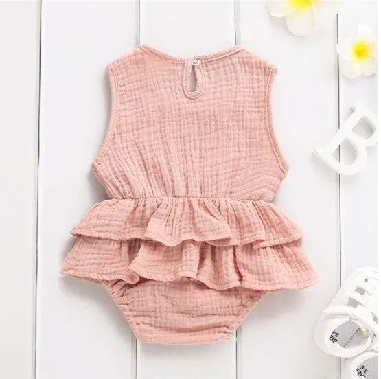 Baby girl sleeveless pettiskirt dress in cotton, shown in pink stripe, with dark buckle and no hood.
