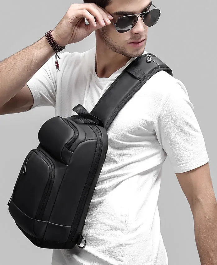 Black medium-sized PVC outdoor shoulder bag showing front view and interior laptop compartment.