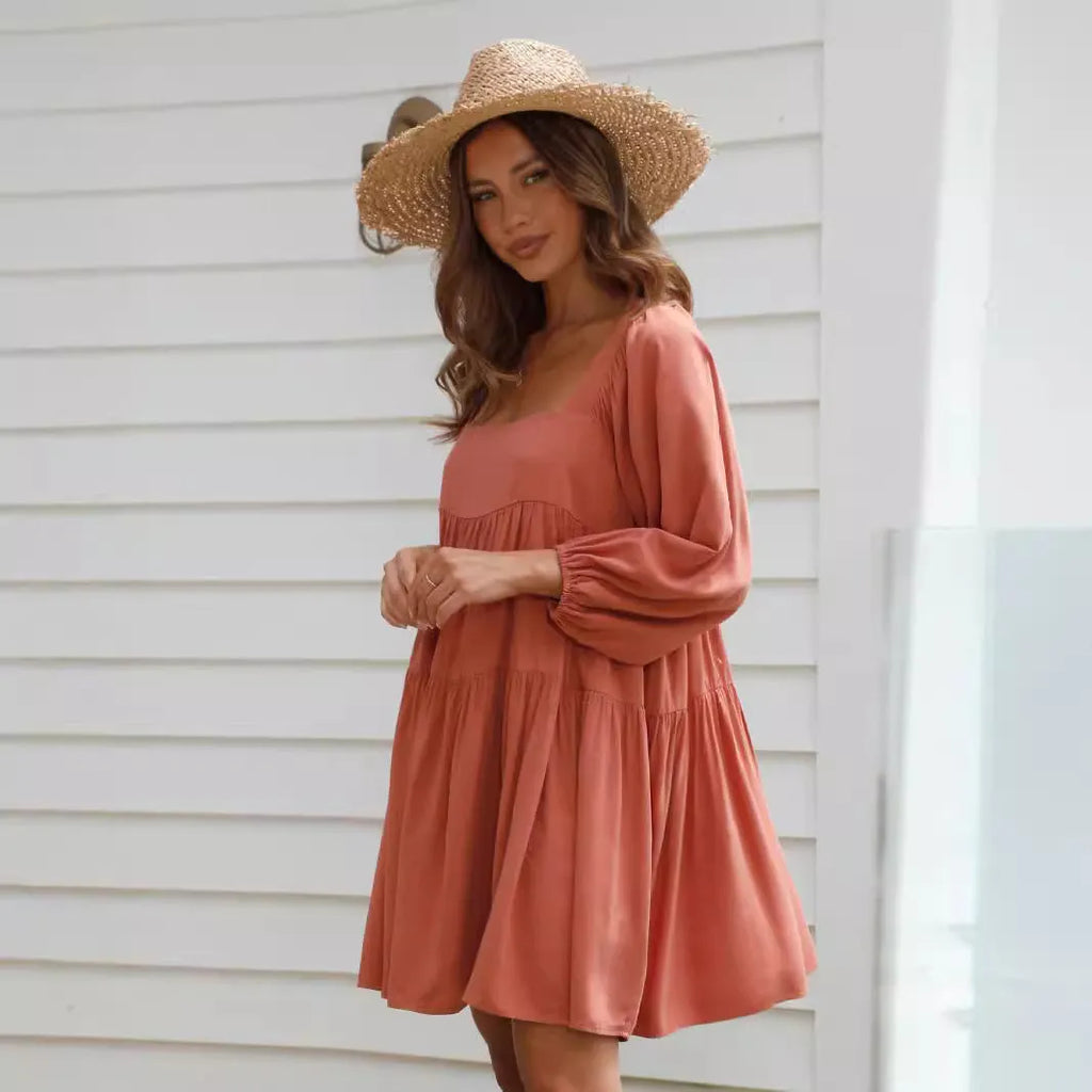 Orange backless children's dress with puff sleeves, a square collar, and a loose A-line skirt.