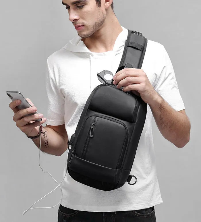 Black medium-sized PVC outdoor shoulder bag showing front view and interior laptop compartment.