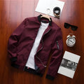 Men's slim fit casual baseball jacket in a solid colour with a stand collar and zippered side pockets.