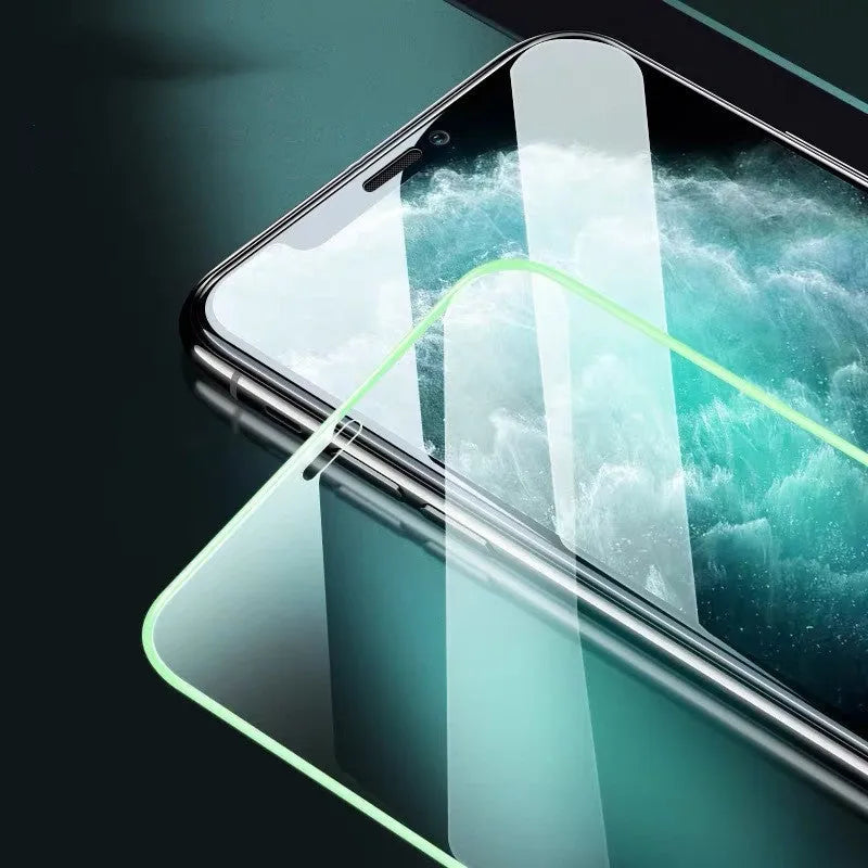 Luminous full cover tempered glass screen protector for iPhone glowing softly in dark conditions.