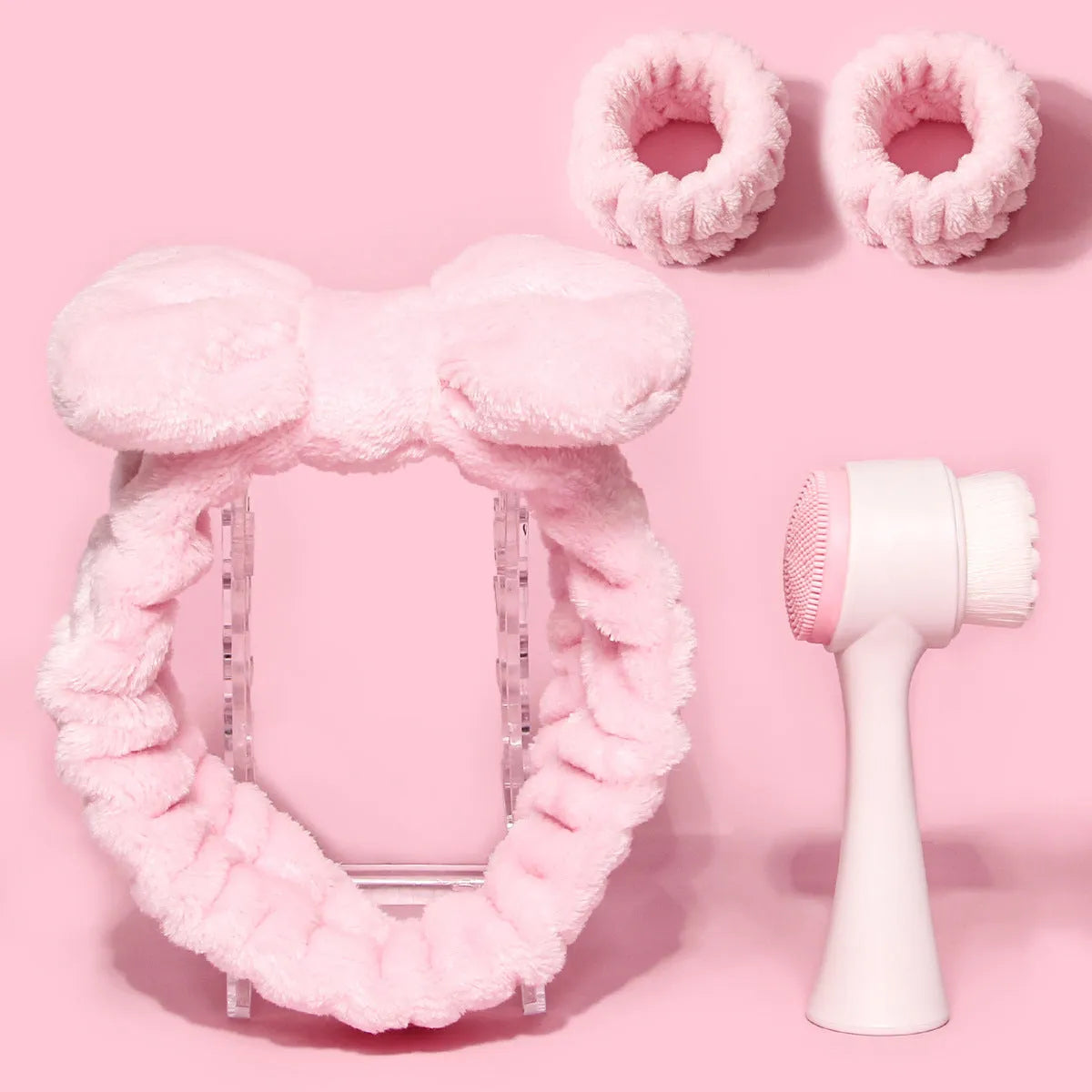 Purple, grey, white, and pink facial brush with coral fleece hair band and multiple brush heads
