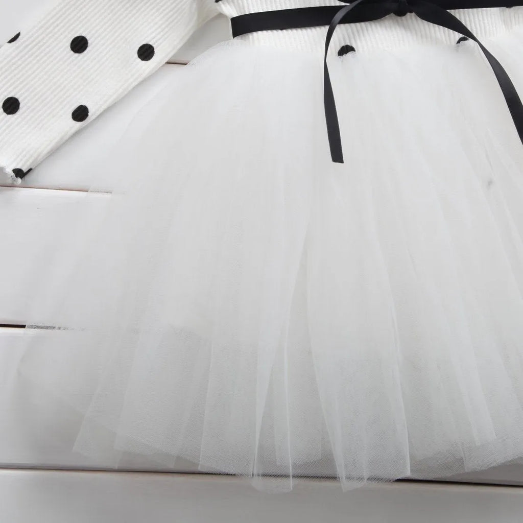 Baby girl in a long sleeve black lace tutu dress, suitable for christenings and parties.