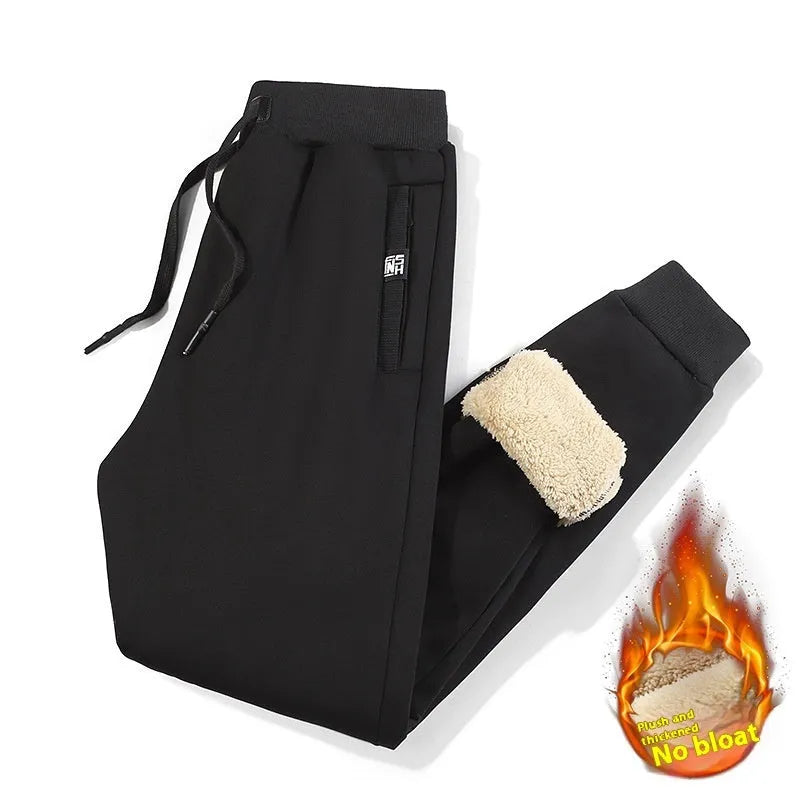 Men's grey fleece-lined oversized track pants with elastic waistband and straight leg design