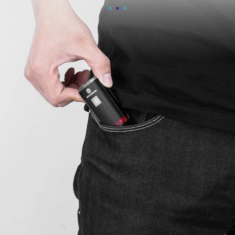 Black bicycle helmet light with aluminium alloy shell showing USB charging port and compact 6.3cm size