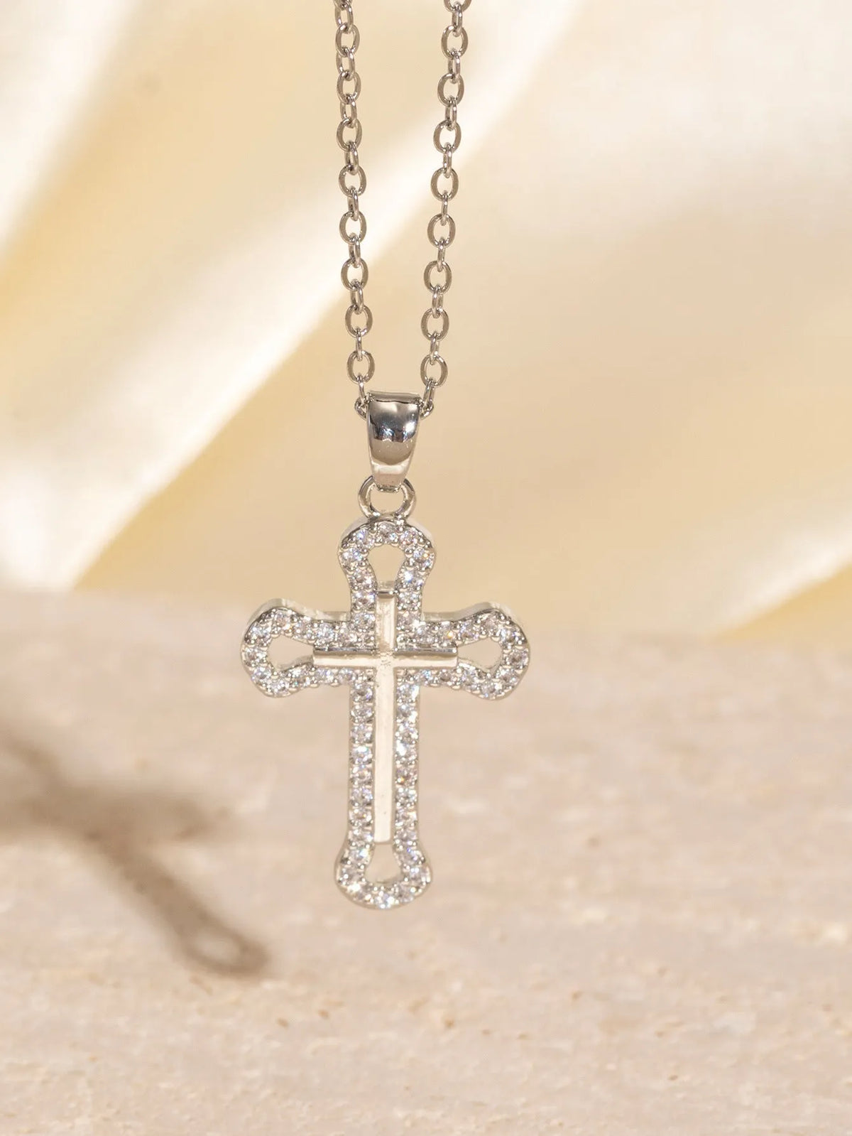 Gold electroplated copper cross necklace with micro inlaid zircon on a 41-50cm O-ring chain.