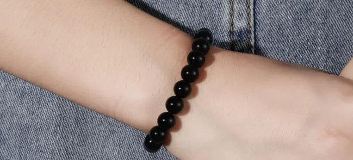 Geometric black agate bracelet with 8mm beads on elastic cord for women.