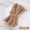 Oval round shoelace in multiple colours showing 1.0cm width, next to a sneaker.