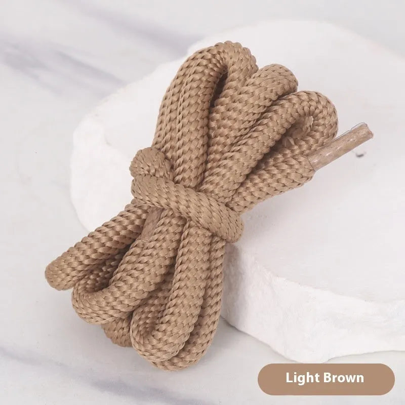 Oval round shoelace in multiple colours showing 1.0cm width, next to a sneaker.