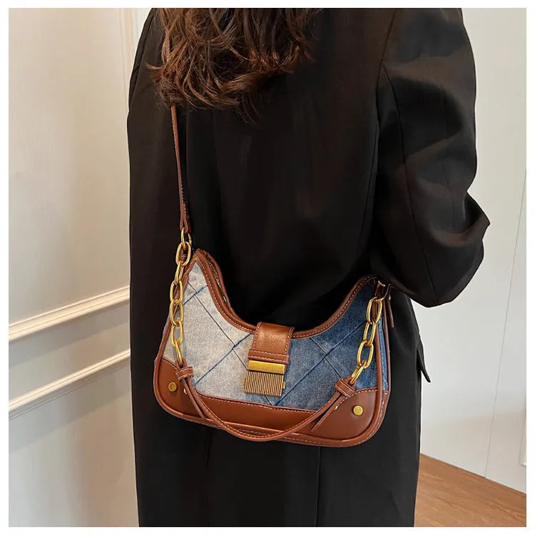 Brown denim bucket shoulder bag with diamond mesh panels and metallic chain strap