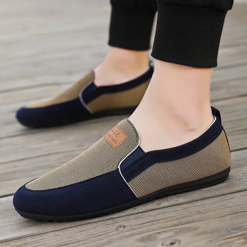 Men's grey canvas lace-up board shoes with round toe and rubber sole on a white background.