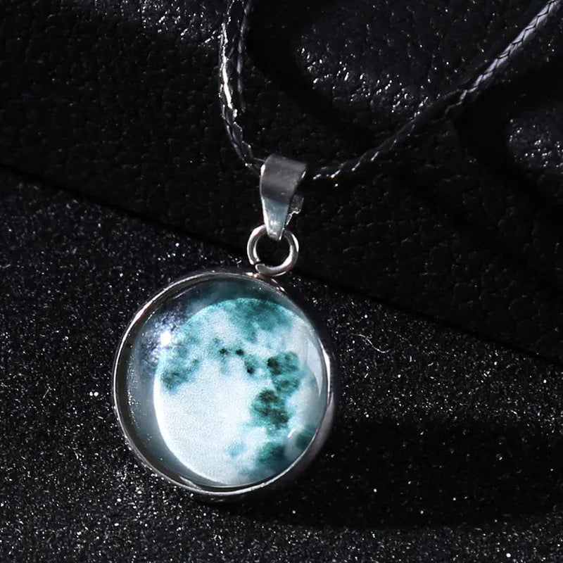 Luminous constellation glass pendant necklace with a moon and night sky design on an adjustable chain