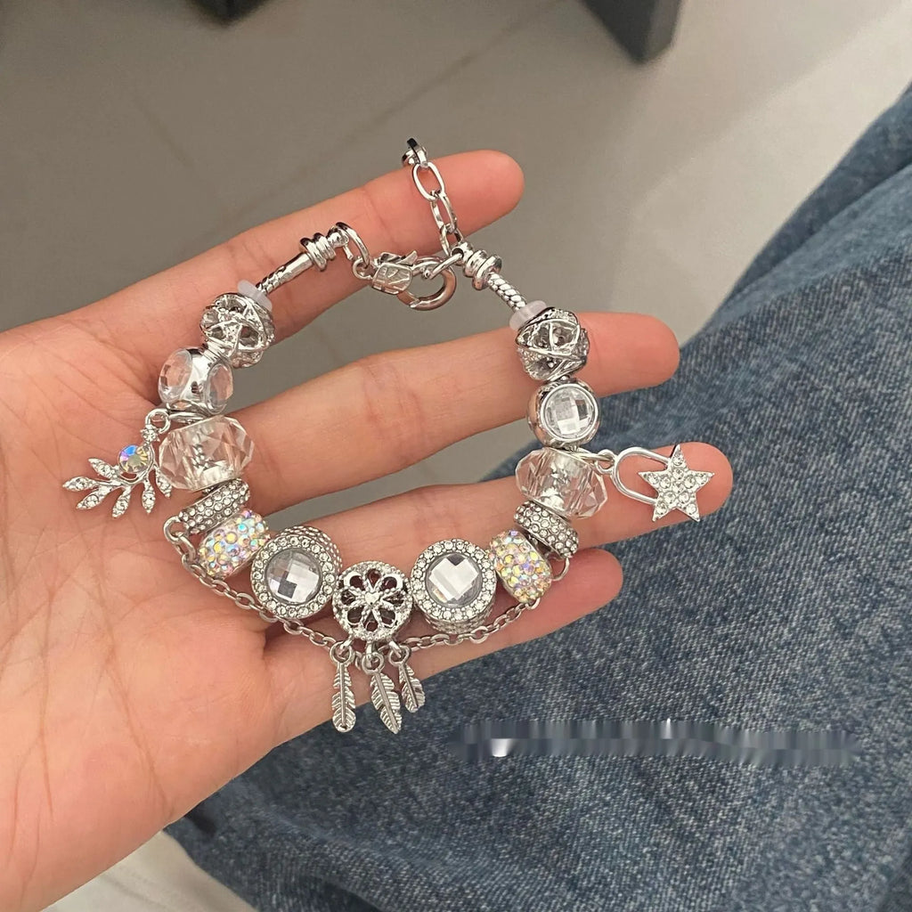 Women's dream catcher star bracelet with colourful crystals and electroplated finish on a white background