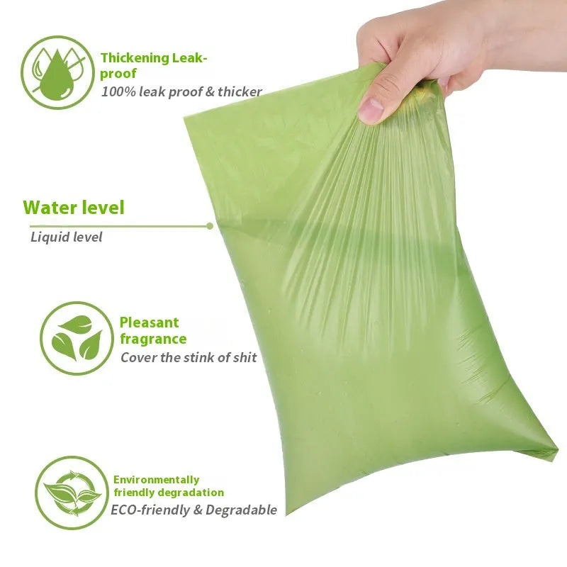 Rolls of green EPI degradable pet waste bags next to a transparent dispenser unit.