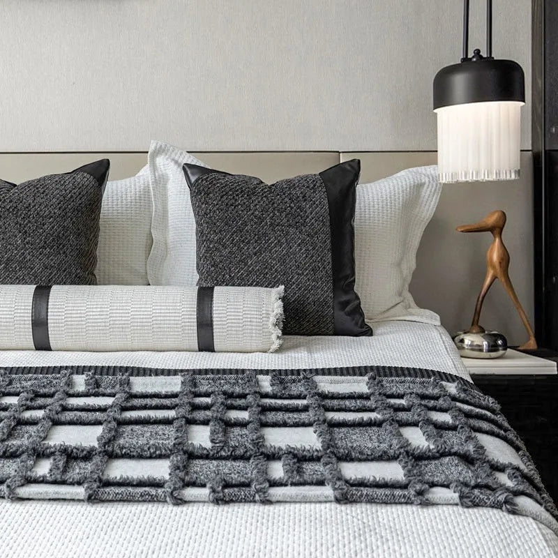 Grey and white plaid polyester bed runner nap blanket set with pillow on a bed.