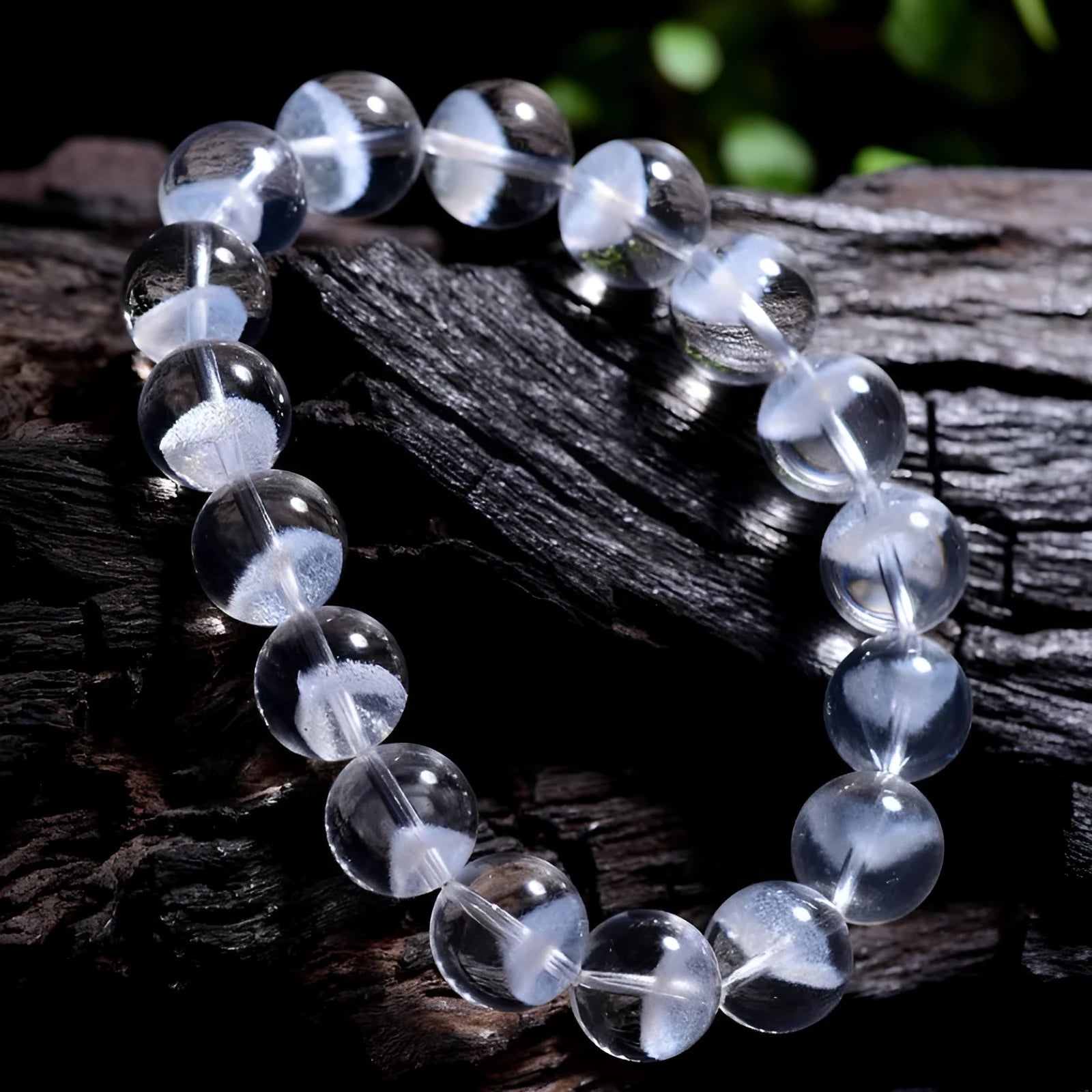 Women's white crystal bracelet with ghost pyramid beads and a ruyi charm, shown on a wrist.