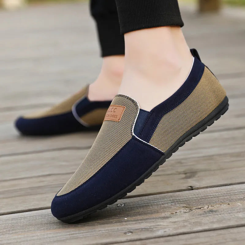Men's grey canvas lace-up board shoes with round toe and rubber sole on a white background.