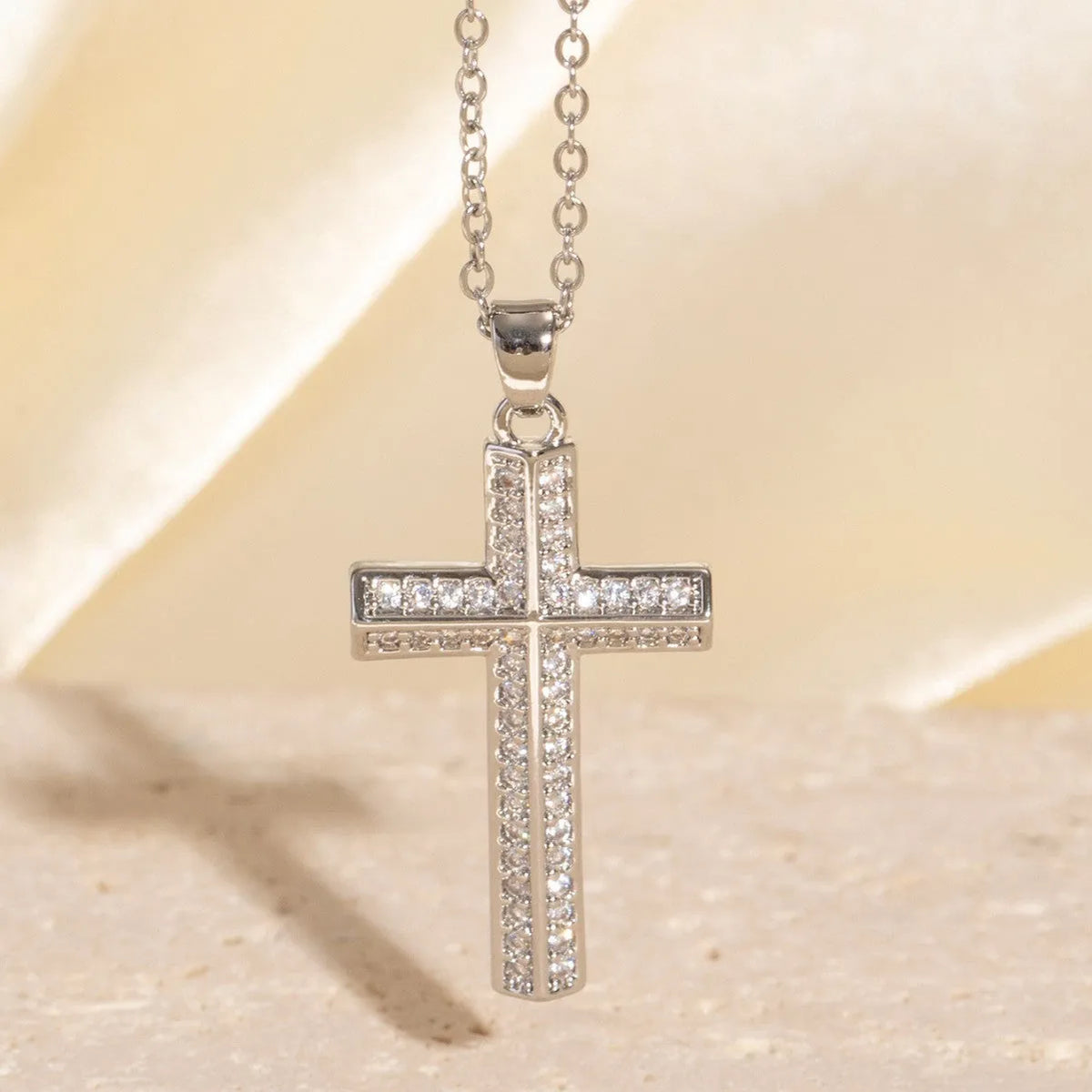 Gold electroplated copper cross necklace with micro inlaid zircon on a 41-50cm O-ring chain.