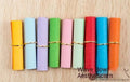 Assorted coloured mini paper scrolls with eyelets in 3x7cm and 7x7cm sizes for drift bottles