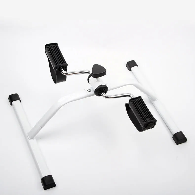 White mini exercise bike with non-slip pedals and monitor on rubber feet