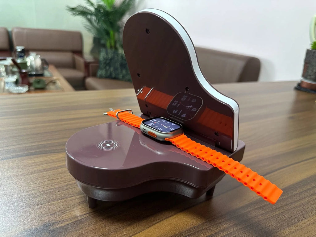 Black 3-in-1 Bluetooth speaker with wireless charger and phone holder on a desk